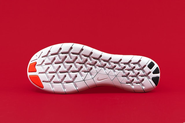 Running shoe sole on a red background