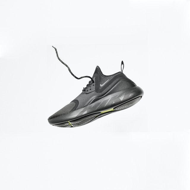 Black running shoe floating against a white backdrop